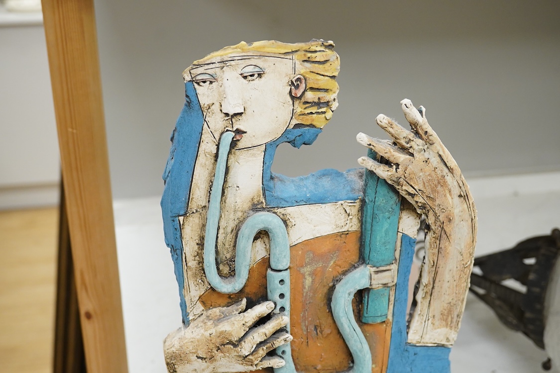 Christy Keeney (b.1958) abstract ceramic study of a figure playing an instrument, signed, 42cm high (damaged)